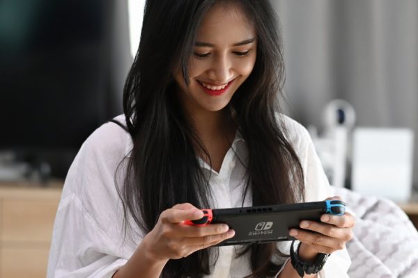 a woman pondering the Best Christmas gifts for gamers 2024